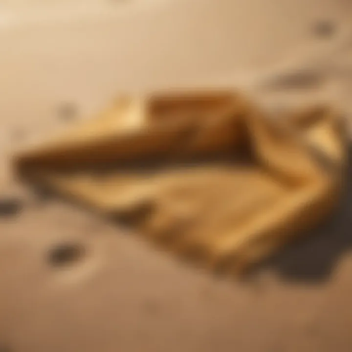 Elegantly styled beach towel displayed on golden sand under the radiant sun