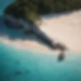 A breathtaking aerial view of an unspoiled beach with turquoise waters and white sands