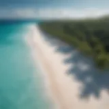 Aerial view of the serene turquoise waters and white sands of a tropical paradise.